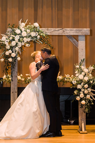 Lara and Rob kiss at the alter