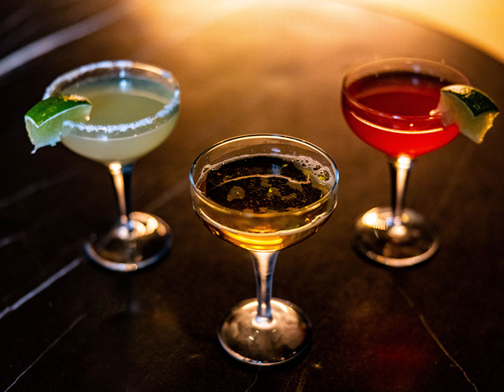 3 cocktails colored green, yellow, and red